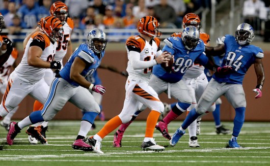 Detroit Lions Ndamukong Suh Nick Fairley and Ezekiel Ansah pursue Cincinnati Bengals Andy Dalton during a game at Ford Field Oct. 20 2013. The Bengals won 27-24. Credit Courtesy of TNS