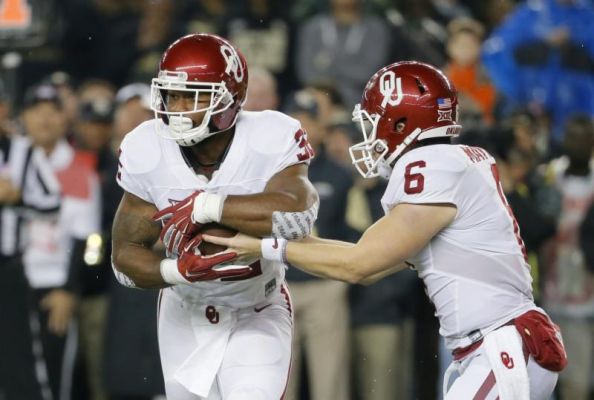 Oklahoma running back Samaje Perine left takes the