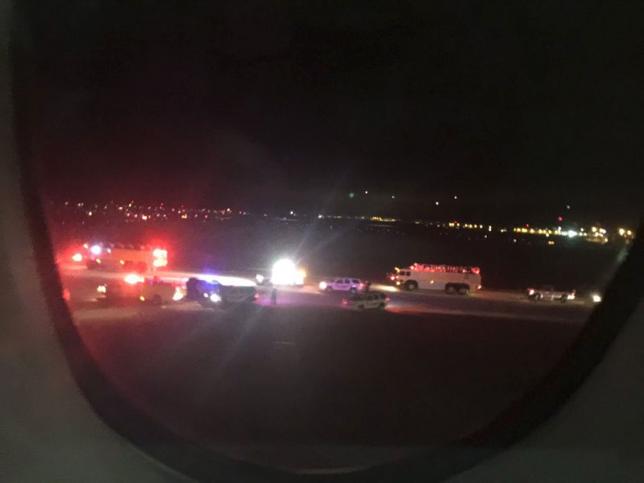 Emergency personnel are shown on the tarmac at Salt Lake City International Airport in this