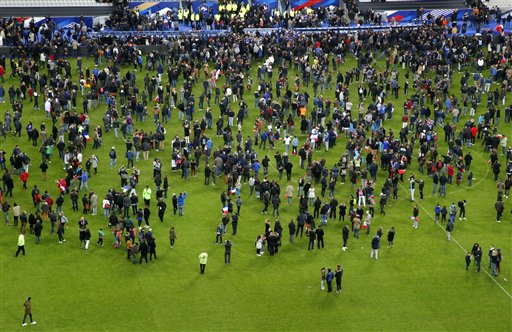 Spectators invade the pitch of the Stade de France stadium after the international friendly soccer France against Germany Friday Nov. 13 2015 in Saint Denis outside Paris. At least 35 people were killed in shootings and explosions around Paris many