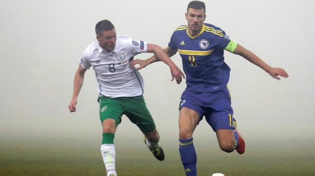 Bosnia striker Edin Dzeko tries to hold off the challenge of James McCarthy of Ireland during last night’s play-off first leg