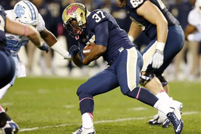 Pittsburgh running back Qadree Ollison runs the ball towards North Carolina linebacker Andre Smith in the first quarter of an NCAA college football game Thursday Oct. 29 2015 in Pittsburgh