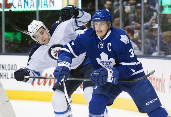 Lowry left and Toronto Maple Leafs Dion Phaneuf fight for position during the first period of an NHL hockey game in Toronto Wednesday Nov. 4 2015. MANDATORY CREDIT