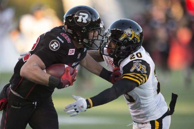 Ottawa Redblacks wide receiver Greg Ellingson fights off Hamilton Tiger Cats defensive back Emanuel Davis as he runs for a touchdown in the fourth quarter in the CFL East Division final in Ottawa on Nov. 22 2015