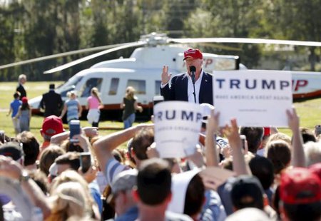 U.S. Republican presidential candidate Donald Trump speaks after arriving in his helicopter as a group of children race towards it for ride during a rally in Sarasota Florida