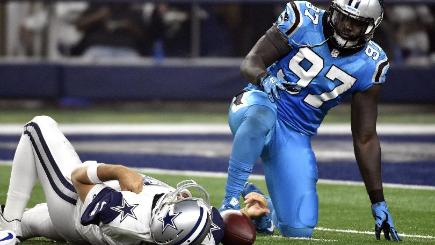 Tony Romo lies injured after being sacked by Thomas Davis