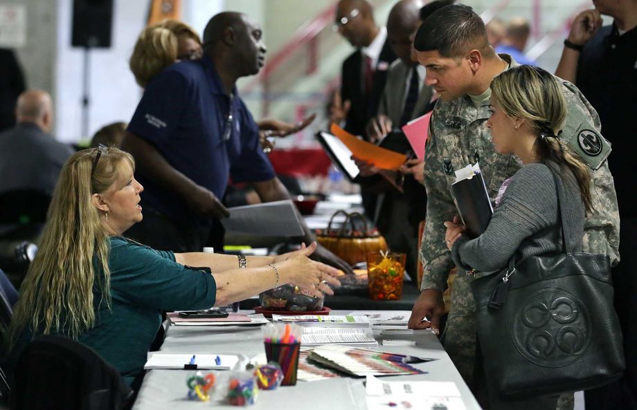 U.S. Army David Torres and his wife Dennise Diaz talk with Sherilyn Leone of Respite Care of San Antonio at the Texas Workforce Commission's “Hiring Red White and You” event earlier this month in San Antonio. Although the jobless rate ticked up