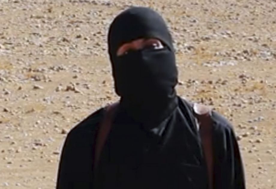 FILE- This still image from undated video released by Islamic State militants on Oct. 3 2014 purports to show the militant known as Jihadi John. A U.S. drone strike targeted a vehicle in Syria believed to be transporting the masked Islamic State milita