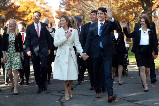 Justin Trudeau and his wife Sophie Gregoire Trudeau walk to Rideau Hall with Trudeau's future cabinet to take part in a swearing-in ceremony in Ottawa on Wednesday