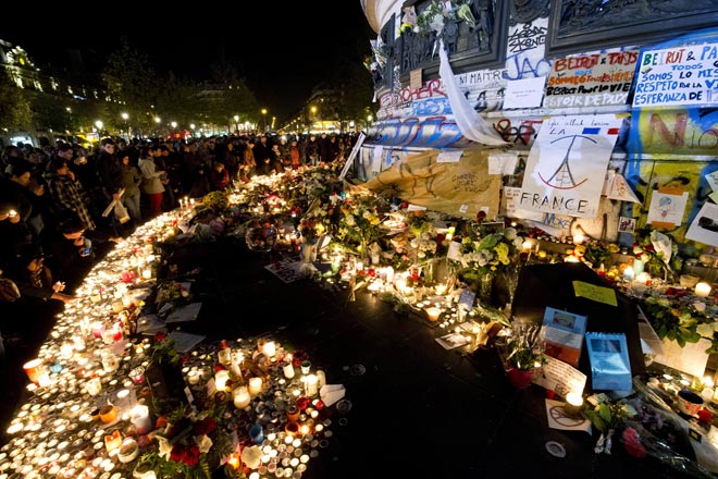 Candles have been lit at a makeshift memorial in tribute to the victims of Paris’ attacks’ at the place de la Republique in Paris. — AFP