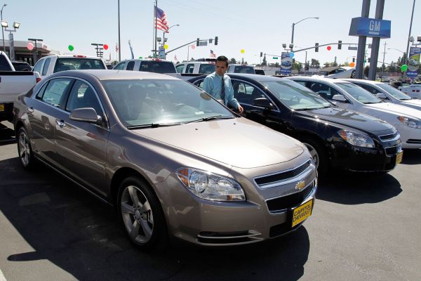 Chevrolet Malibus are lined up at a car