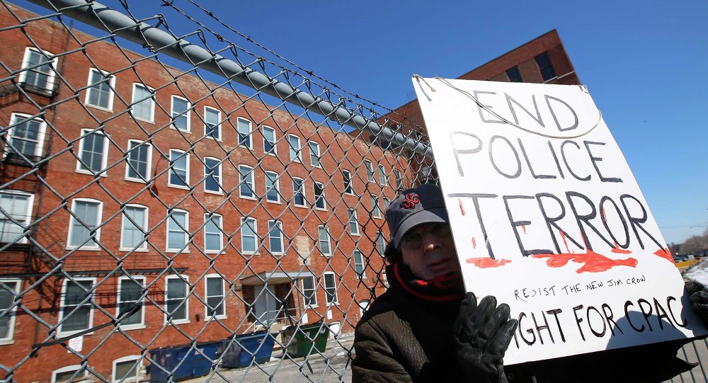 A protestor stands outside a police facility called Homan Square demanding an investigation into a media report denied by police that the site functions as an off-the-books interrogation compound in Chicago Illinois