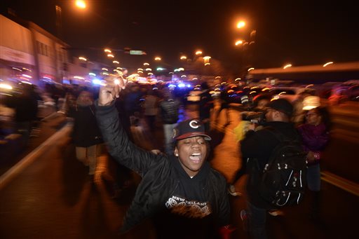 Protesters march during a demonstration for 17-year-old Laquan McDonald who was fatally shot and killed Oct. 20 2014 in Chicago. Chicago police officer Jason Van Dyke was charged Tuesday Nov. 24 2015 with first degree murder in the killing. (AP Phot