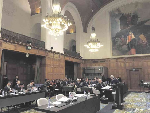 Philippine lead external counsel Paul Reichler confers with Solicitor General Florin Hilbay during round two oral arguments in the territorial dispute between the Philippines and China at the UN arbitral court in The Hague on Tuesday. The empty