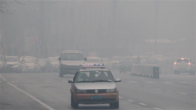 Cars are seen moving amid toxic smog in Changchun northeast China