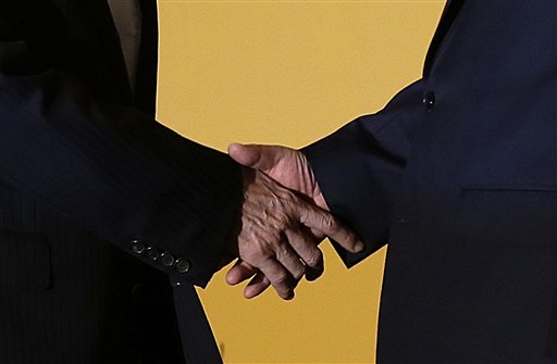 Chinese President Xi Jinping right and Taiwanese President Ma Ying-jeou left shake hands at the Shangri-la Hotel on Saturday Nov. 7 2015 in Singapore. The two leaders shook hands at the start of a historic meeting marking the first top level conta