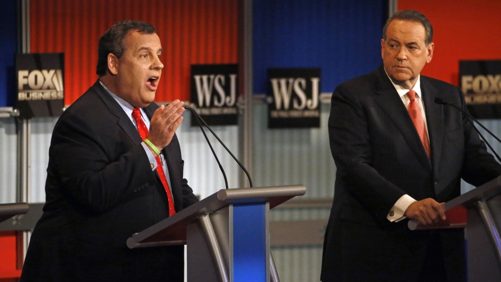 Chris Christie left makes a point as Mike Huckabee listens during Republican presidential debate in Milwaukee Wis. on Tuesday