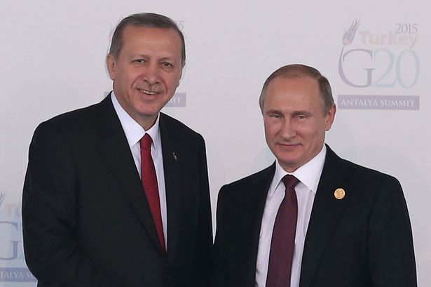 Russian President Vladimir Putin is greeted by Turkish President Recep Tayyip Erdogan at the G20 Summit