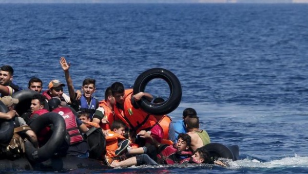 Syrian and Afghan refugees fall into the sea after their dinghy deflated some 100m away before reaching the Greek island of Lesbos Sep.13 2015