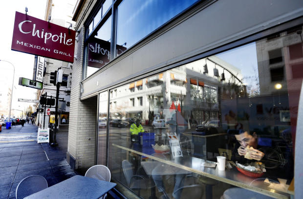 A customer enjoys lunch at a Chipotle restaurant in Portland Ore. Wednesday Nov. 11 2015. Chipotle started reopening its restaurants in the Pacific Northwest on Wednesday after an E. coli outbreak sickened about 45 people a high-profile example of