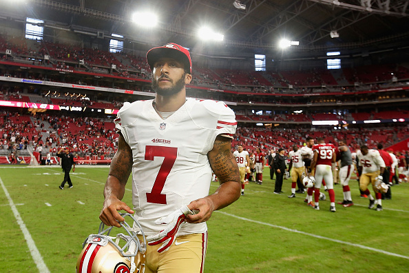 Quarterback Colin Kaepernick #7 of the San Francisco 49ers walks off the field after being defeated by the Arizona Cardinals 47-7 in the NFL game at the University of Phoenix Stadium