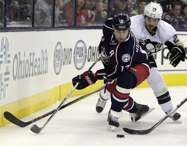 Columbus Blue Jackets Brandon Dubinsky left tries to pass the puck as Pittsburgh Penguins Ian Cole defends during the second period of an NHL hockey game Friday Nov. 27 2015 in Columbus Ohio