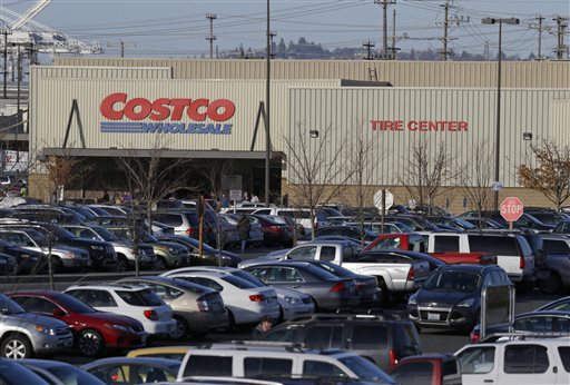 Cars fill the parking lot of a Costco store Tuesday Nov. 24 2015 in Seattle. Health authorities say chicken salad from Costco has been linked to at least one case of E. coli in Washington state