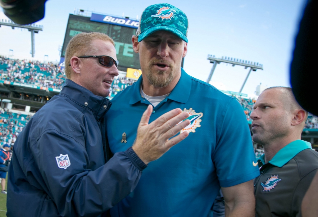 Dallas Cowboys head coach Jason Garrett greets Miami Dolphins interim head coach Dan Campbell after the Cowboys 24-14 win at Sun Life Stadium