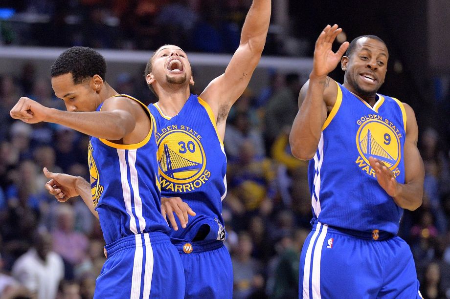 Golden State Warriors guards Shaun Livingston left Stephen Curry, and Andre Iguodala celebrate after Curry's three-point score to beat the buzzer at the end of the third quarter during an NBA basketball game against the Memphis Grizzlies Wedne