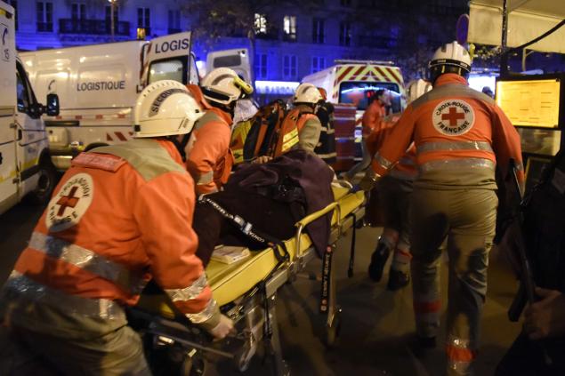 French Red Cross rescue workers evacuate an injured person near the Bataclan