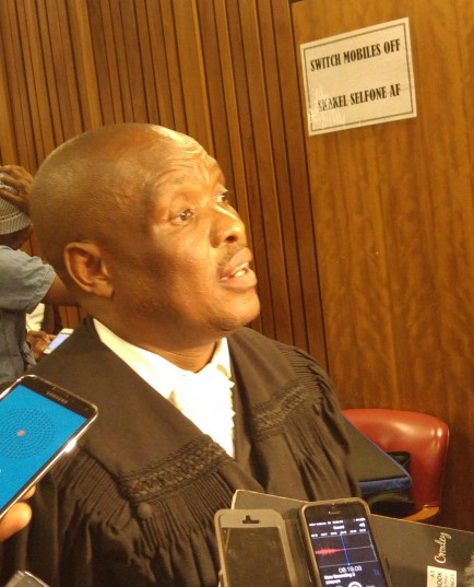 Former policemen front left to right Meshack Malele Thamsanqa Ngema Percy Mnisi Bongamusa Mdluli Sipho Ngobeni Lungisa Gwababa Bongani Kolisi and Linda Sololo in the High Court in Pretoria South Africa on Tuesday