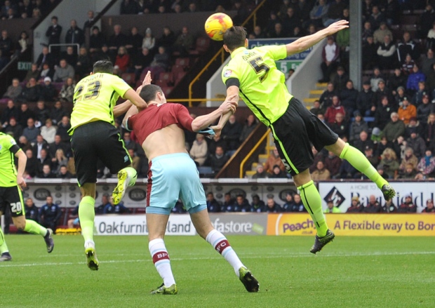 Michael Keane has his shirt pulled by Brighton's Liam Rosenior and Lewis Dunk