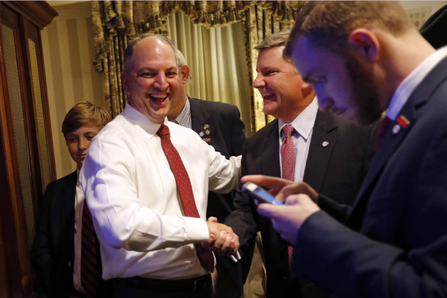 Louisiana Democratic gubernatorial candidate Rep. John Bel Edwards greets supporters as he watches election returns in a hotel suite at his election night watch party in New Orleans Saturday Nov. 21 2015