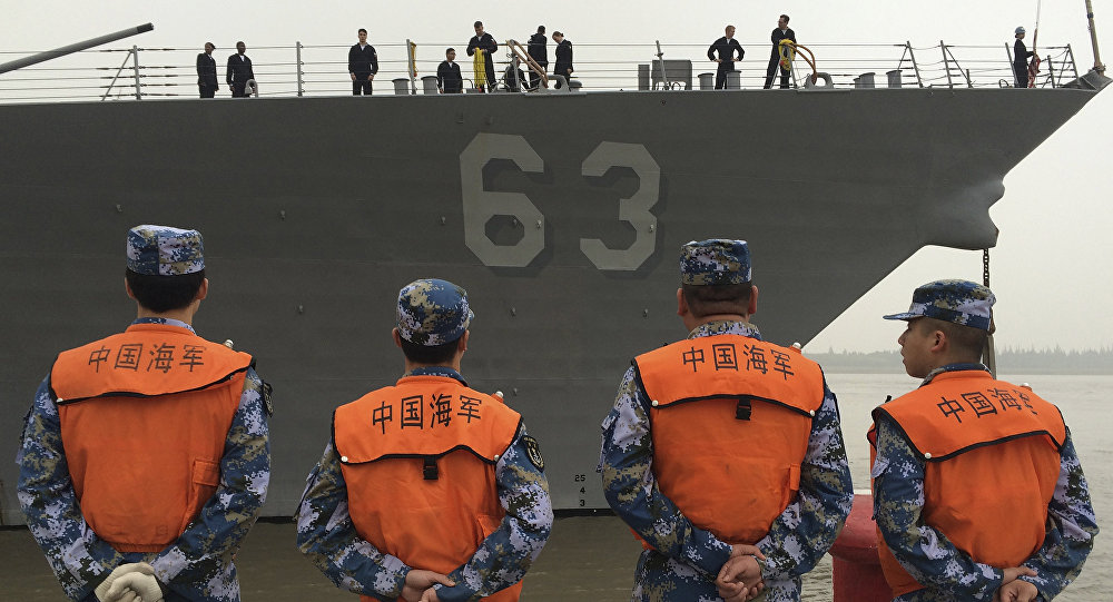 Chinese Navy personnel stand watch the guided missile destroyer USS Stethem arrives at the Shanghai International Passenger Quay for a scheduled port visit in Shanghai China Monday Nov. 16 2015