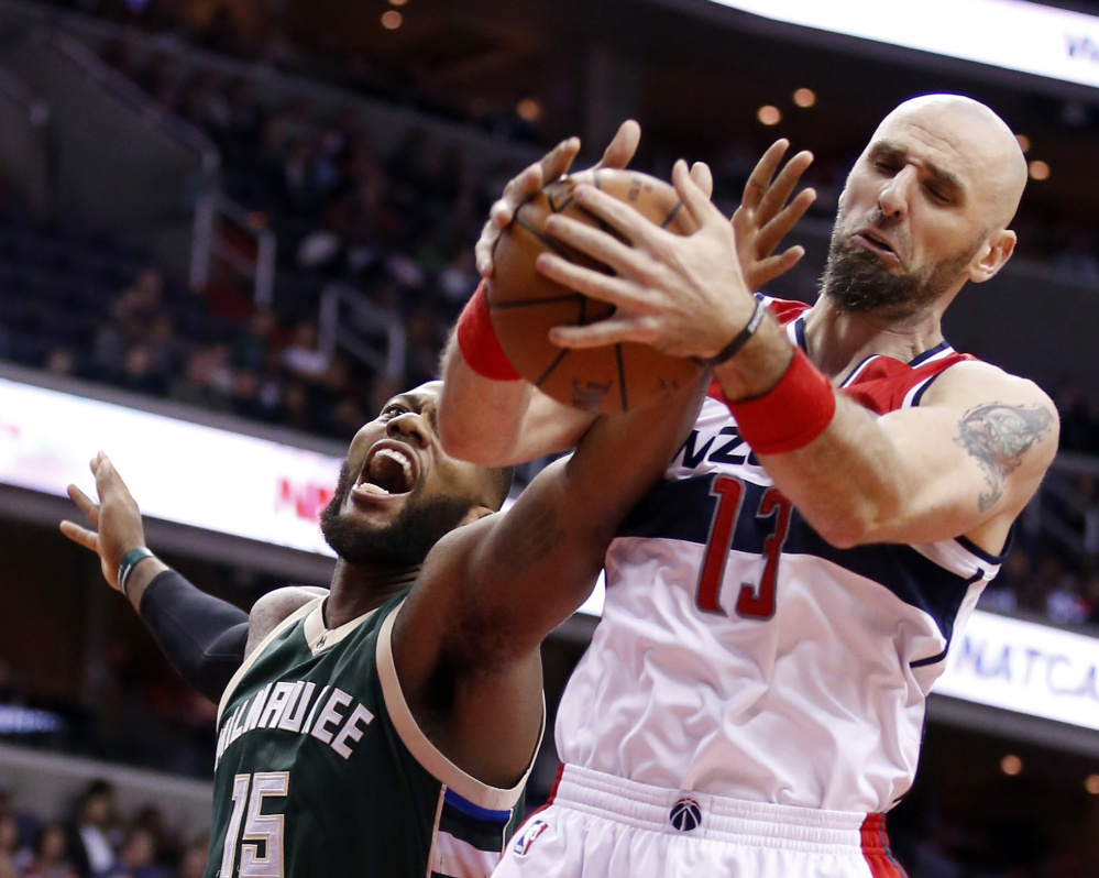 Bucks center Greg Monroe left attempts to keep a rebound from the arms of Wizards center Marcin Gortat during Tuesday’s game a 115-86 Washington home win