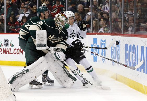 Darcy Kuemper collides with Dallas Stars center Mattias Janmark right of Sweden as Wild defenseman Gustav Olofsson of Sweden backs Kuemper during the second period of an NHL hockey game in St. Paul Minn. Saturd