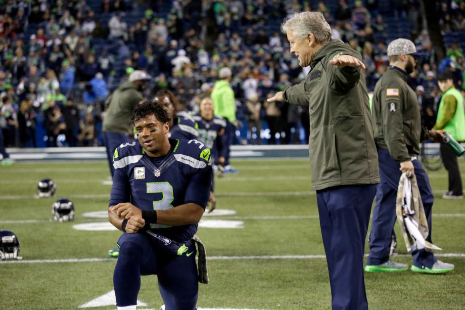 Seattle Seahawks quarterback Russell Wilson left talks with head coach Pete Carroll before an NFL football game Sunday against the Arizona Cardinals Nov. 15 2015 in Seattle