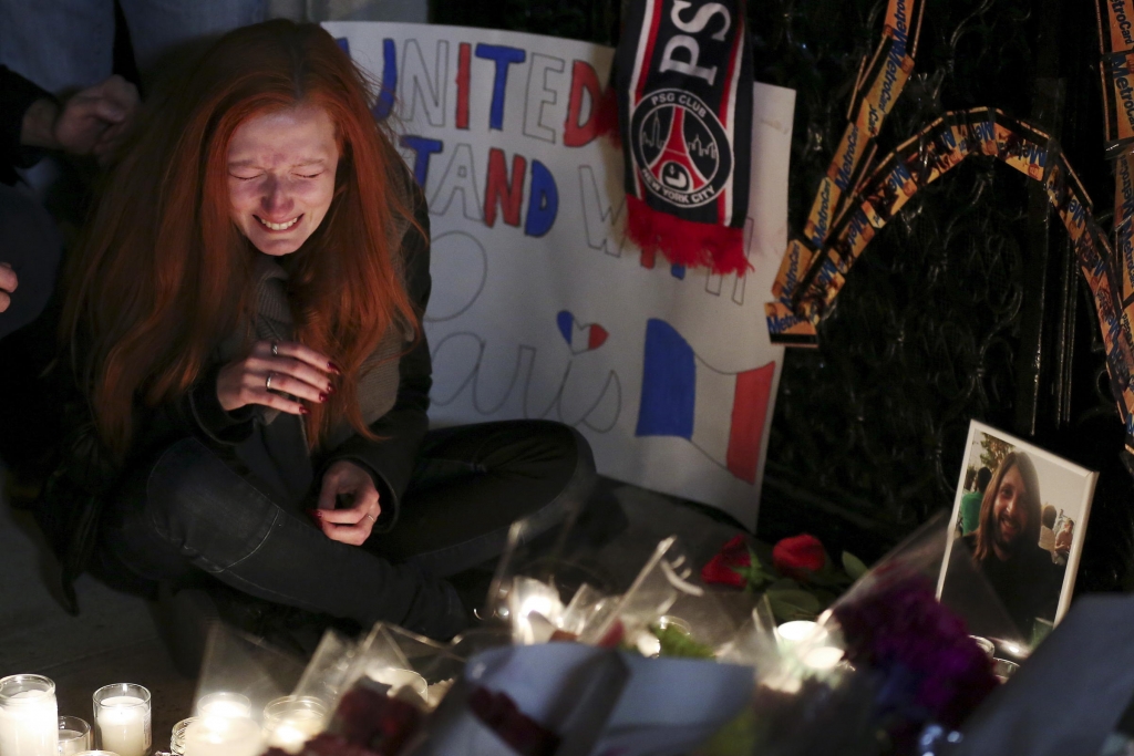 Polina Buckley the girlfriend of Eagles Of Death Metal's merchandise manager Nick Alexander who died in attacks in Paris cries as she sits near a makeshift memorial outside the consulate of France in New York