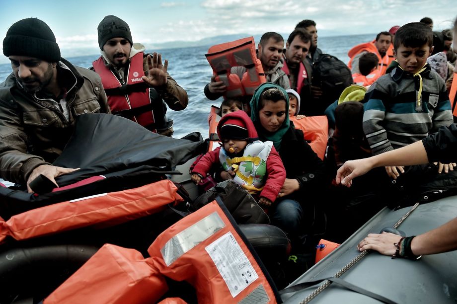 Refugees arrive on the Greek island of Lesbos after crossing the Aegean Sea from Turkey