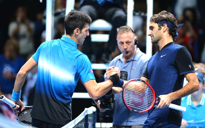 Switzerland's Roger Federer shakes hands with Serbia's Novak Djokovic after winning his men's singles group stage match on day three of the ATP World Tour Finals tennis tournament in London. Pic  AFP