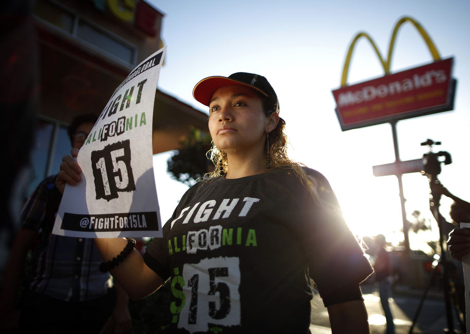 Demonstrators take part in a protest to demand higher wages for fast-food workers outside McDonald's in Los Angeles California