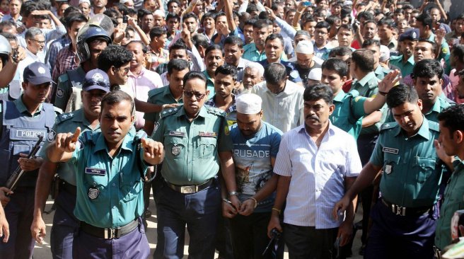 Bangladesh police escort a suspect in a murder case involving the brutal killing of a child at a court in Sylhet