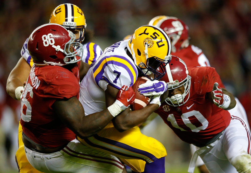 Leonard Fournette #7 of the LSU Tigers is tackled by Reuben Foster #10 and Truett Harris #86 of the Alabama Crimson Tide in the third quarter at Bryant Denny Stadium