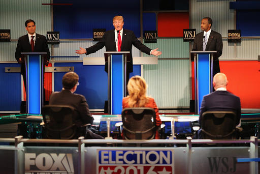 Presidential candidate Donald Trump speaks while Sen. Marco Rubio and Ben Carson look on during the Republican Presidential Debate at the Milwaukee Theatre Nov. 10 2015 in Milwaukee Wis