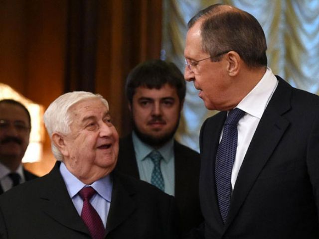 Russian Foreign Minister Sergei Lavrov speaks with his Syrian counterpart Walid Muallem during their meeting in Moscow