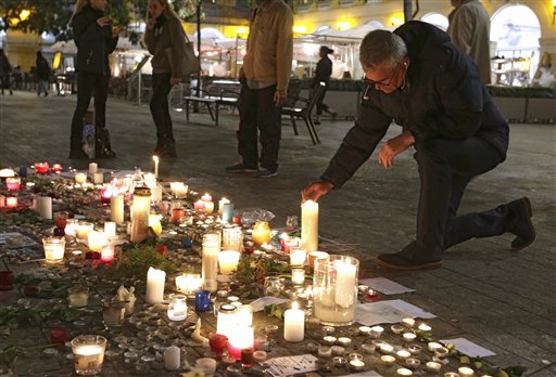 A man pays tribute to the victims of the terror attacks in Paris in Nice southeastern France Monday Nov. 16 2015. France is urging its European partners to move swiftly to boost intelligence sharing fight arms trafficking and terror financing and