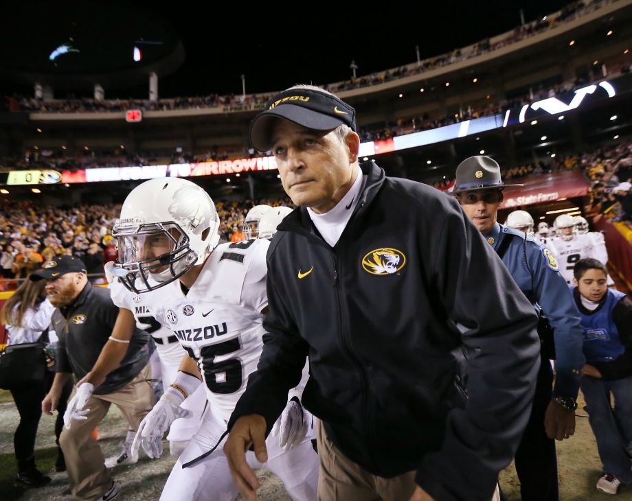 Missouri head coach Gary Pinkel leads his players onto the field before a game against BYU on Saturday in Kansas City