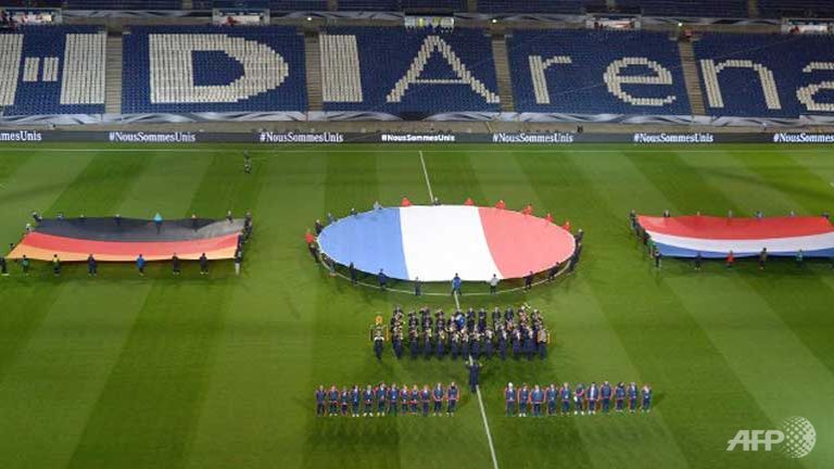 German French and Dutch flags are seen during a rehearsal prior to a friendly football match in Barsinghausen Germany