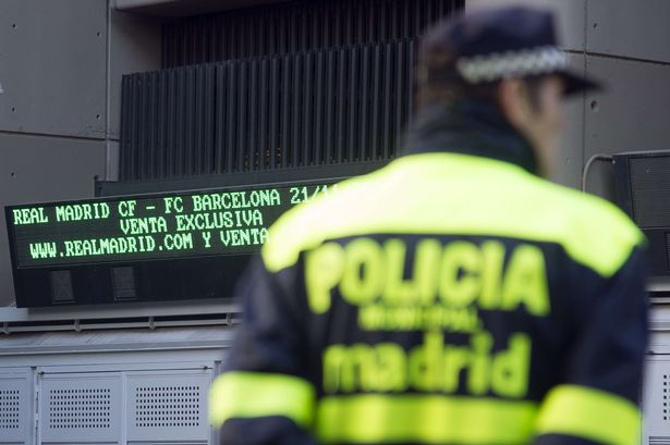 Local police officers patrol nearby the Santiago Bernabeu stadium