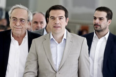 Greek Prime Minister Alexis Tsipras is escorted by Minister of Culture Education and Religious Affairs Aristides Baltas and government spokesman Gabriel Sakellaridis during his visit at the ministry in Athens